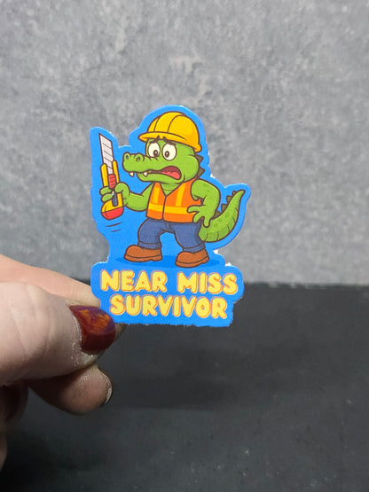Near Miss Survivor - LDC - Bulk Pack of 16 Stickers - Apx 2in - Water Resistant Stickers